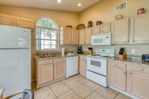 a kitchen with white appliances and a window at Safari Lodge in Orlando
