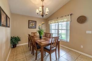 a dining room with a wooden table and chairs at Safari Lodge in Orlando
