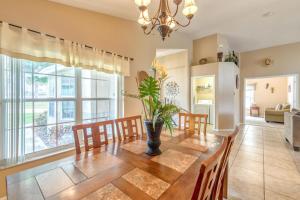 a dining room with a wooden table and chairs at Safari Lodge in Orlando
