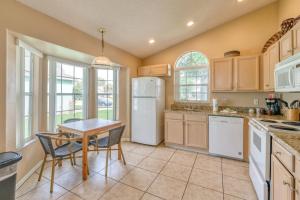 a kitchen with a table and a white refrigerator at Safari Lodge in Orlando