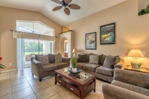 a living room with couches and a table at Safari Lodge in Orlando