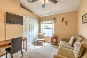 a living room with a couch and a desk at Safari Lodge in Orlando