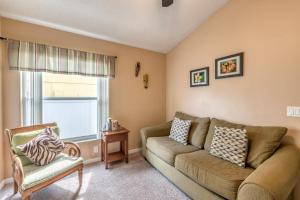 a living room with a couch and a chair at Safari Lodge in Orlando