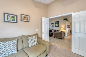 a living room with a couch and a chair at Safari Lodge in Orlando
