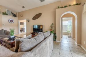 a living room with two couches and a tv at Safari Lodge in Orlando