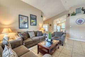 a living room with couches and a table at Safari Lodge in Orlando