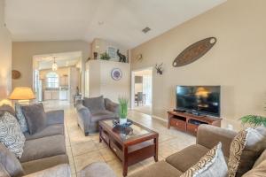a living room with couches and a flat screen tv at Safari Lodge in Orlando