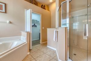 a bathroom with a shower and a tub and a sink at Safari Lodge in Orlando
