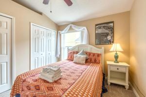 a bedroom with a bed with an orange bedspread at Safari Lodge in Orlando