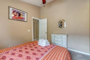 a bedroom with a bed and a picture on the wall at Safari Lodge in Orlando