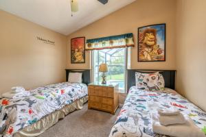 a bedroom with two twin beds and a window at Safari Lodge in Orlando