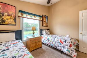 a bedroom with two beds and a window at Safari Lodge in Orlando