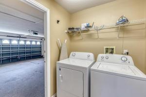 a laundry room with a washer and dryer at Safari Lodge in Orlando