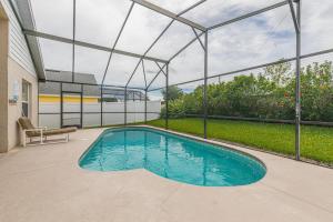a swimming pool in a house with a glass ceiling at Safari Lodge in Orlando