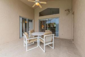 a dining room table with chairs and a ceiling fan at Safari Lodge in Orlando