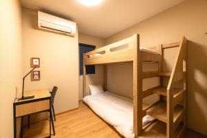 Ένα ή περισσότερα κρεβάτια σε δωμάτιο στο TEN APARTMENT HOTEL Hakata Reisen