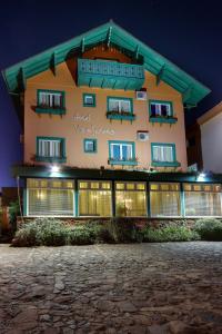 a large building with windows at night at Hotel Via Serena in Gramado