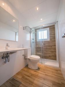 a bathroom with a toilet and a glass shower at Apartamentos AR Muntanya Mar in Blanes