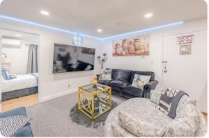 a living room with a couch and a chair at Exquisite 3 Bedrooms in Newark