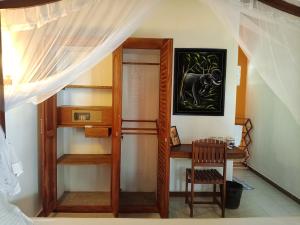 a room with a desk and a bunk bed at Seethani Beach Hotel in Hikkaduwa