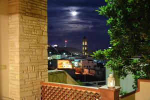 a view of a city at night from a window at Leuca Residence in Leuca