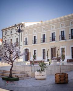 a large white building with a tree in front of it at Hotel Rural el Turuñuelo in Guareña