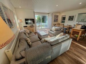 a living room with a couch and a table at Carn Du 1 in Padstow
