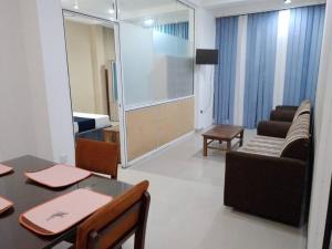 a living room with a table and a couch at Dil Apartments - Mount Lavinia in Mount Lavinia