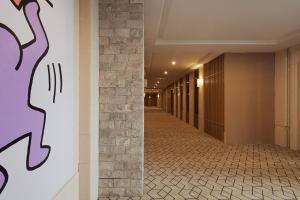 a corridor of a building with a stone wall at Mcsrh Hotel-Chongqing Guanyinqiao in Chongqing