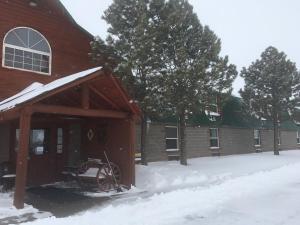 a barn with snow on the roof of it at Buffalo Lodge in Chugwater +2 photos