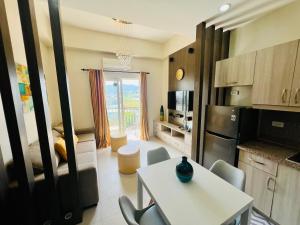 a kitchen with a table and chairs in a room at City Center 1-bedroom with balcony and washer in Cebu City