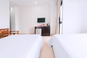 Llit o llits en una habitació de Lotus Rock Hotel Đà Nẵng