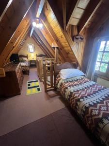 a bedroom with two beds in a attic at Holiday Home Las Retamas in San Martín de los Andes