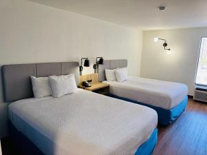 a hotel room with two beds and a window at Sleep Inn in Manassas