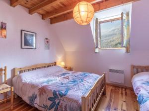 a bedroom with two beds and a window at Appartement T4 7 pers, parking, proche stations ski - FR-1-402-145 in Luz-Saint-Sauveur