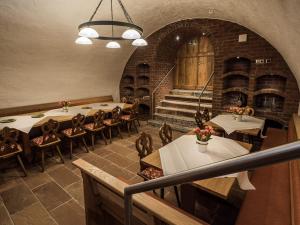 a restaurant with tables and chairs and a staircase at Gasthaus zur Krone in Weingarten (Karlsruhe)