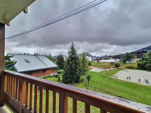 a view from the balcony of a house with a basketball court at Appartement 6 pers, cœur de station, proche pistes et commerces - FR-1-416-226 in La Toussuire