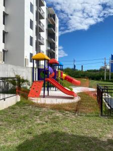a playground with a slide in a park at Hermoso APARTAMENTO EN RICAURTE-BAHIA SOLERO in Ricaurte