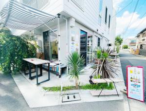 a building with a table and benches on the street at Chill Fortuna Shimokitazawa Tokyo in Tokyo
