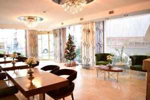 a room with tables and chairs and a christmas tree at Taksim Line Hotel in Istanbul