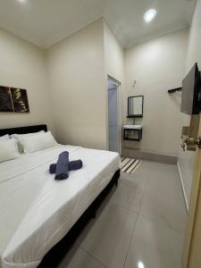 a bedroom with a large bed and a television at SZ Hotel in Malacca +4 photos