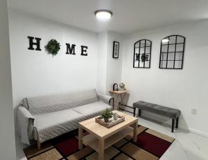 a living room with a couch and a table at Luxury Guest Home - 10 Min to JFK in Jamaica +8 photos