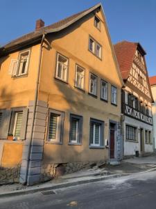 a yellow building on the side of a street at Wohnung 40 Quadratmeter in Arnstein