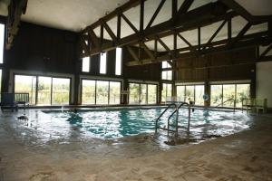 a large indoor swimming pool with glass windows at Benmiller Inn & Spa in Goderich