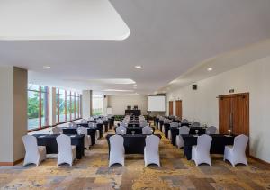 a room with rows of tables and chairs in it at PRIME PARK Hotel & Convention Pekanbaru in Pekanbaru +43 photos
