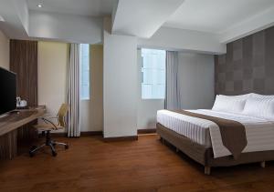 Postel nebo postele na pokoji v ubytování PRIME PARK Hotel & Convention Pekanbaru