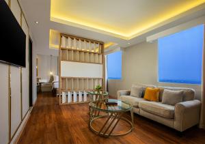 a living room with a couch and a table at PRIME PARK Hotel & Convention Pekanbaru in Pekanbaru