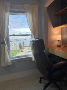 a office with a desk and a chair and a window at Colonels Quarters in Eastport +18 photos