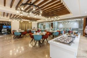 a restaurant with tables and chairs in a room at Rang Lords Inn Bharuch in Bharūch