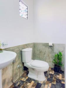 a bathroom with a toilet and a sink at Villa Vinuth Bliss in Mirissa